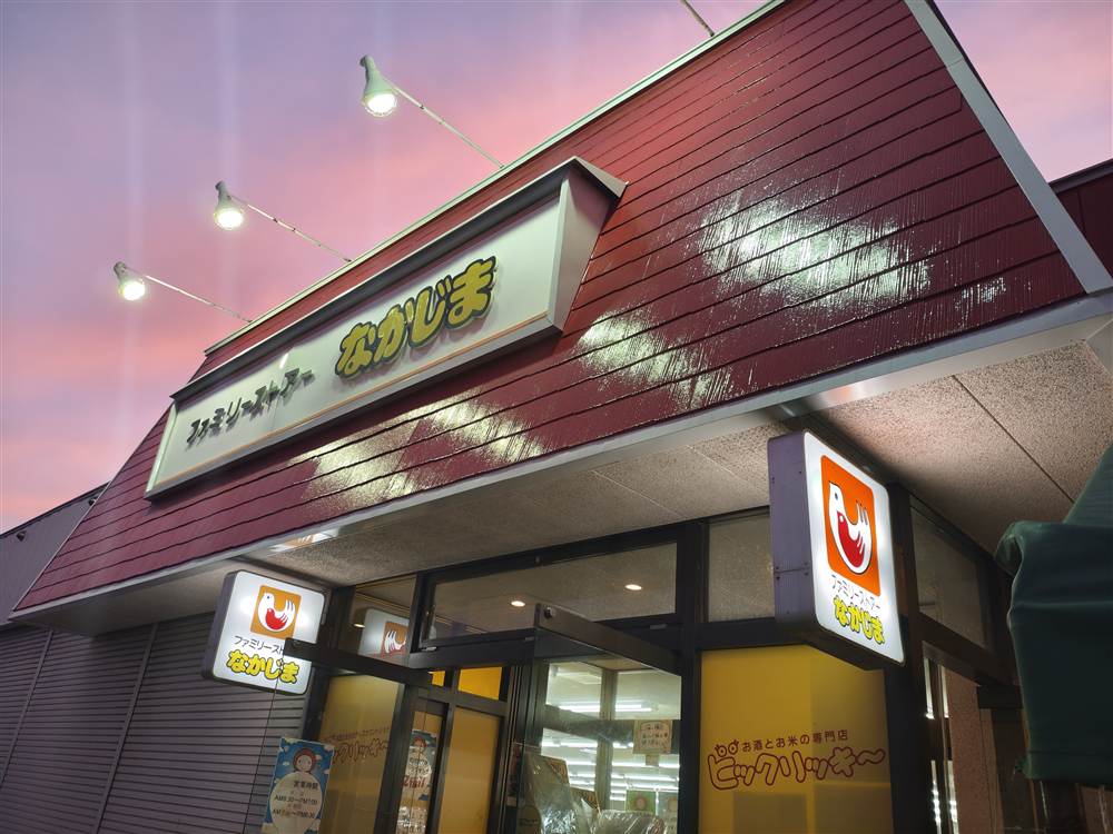 夕焼けの中のファミリーショップなかじまの外観